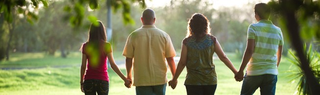 Four adults walking hand in hand